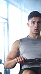 Workout, rowing machine and man in gym for energy, wellness and body health. Sports club, male person and exercise on ergometer for fitness, muscle strength or core training for intense cardio