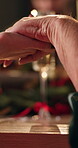 Holding hands, Christmas and prayer with family at dining room for gratitude, festive season and love. Spiritual, celebration and dinner with people in home for faith, xmas holiday and bokeh