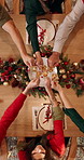 Champagne, cheers and hands of people at christmas dinner in home with celebration, holidays and festive. Sparkling wine, toast and top view of family with alcohol at xmas gathering in dining room.