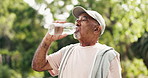 Elderly man, fitness and drinking with water in nature for workout break, rest or recovery. Active, senior or male person with mineral liquid, thirst or natural sustainability for refreshment in park