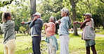 Fitness, yoga class and old people in nature with stretching, wellness and training together with instructor. Exercise, man or woman outdoor with coach, body movement or senior activity in retirement