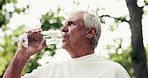 Senior man, fitness and drinking with water in nature for workout break, rest or recovery. Active, elderly or male person with mineral liquid, thirst or natural sustainability for refreshment in park