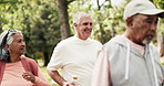 Fitness, old people and power walk with friends in nature for health, wellness or talk to coach. Smile, group and exercise class at park for low impact cardio, workout or retirement with instructor