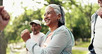 Old woman, group and aerobics exercise at park for functional fitness, funny warm up and cardio. Active retirement, senior people or laughing with coach outdoor for brisk walking and mobility workout