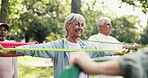 Fitness class, old woman and exercise in park with resistance band, happiness or stretching arms. Group, active elderly person and smile outdoor with elastic for workout, mobility or muscle strength.