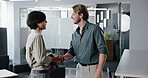 Happy man, meeting and greeting with handshake in office for business chat, introduction or deal. Male person, creative employees or colleagues shaking hands with conversation for discussion at work