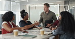 Business people, meeting and handshake in boardroom for introduction, welcome and stakeholder gathering. Paperwork, investment team and financial analyst shaking hands for greeting, charts and graphs