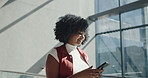 Creative woman, walking and chatting with phone in building for social media or communication. Female person, employee or user texting with smile on mobile smartphone for conversation or network