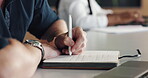 Man, hands and writing in office with journal for marketing campaign schedule, reminder and laptop. Creative, person and coworking with computer for planner, advertising calendar and agenda notes.