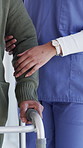 Senior person, nurse and hands with walker for assisted living, mobility or physiotherapy in clinic. Closeup, caregiver and helping elderly patient with balance for physical therapy in hospital