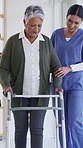 Senior woman, nurse and assisted living with walker for mobility or physiotherapy in clinic. Female person, caregiver and helping patient with smile for physical activity or therapy in hospital