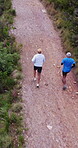 Exercise, drone or men with trail running on mountain for pace training, marathon practice or health. Aerial, back of mature people and cardio workout on dirt road for endurance challenge and fitness