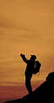 Man, silhouette and fist pump with backpack on mountain for winning, trekking success or conquer. Active, male person or hiker with celebration on outdoor cliff for hiking journey or night adventure