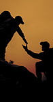 People, silhouette and helping hand for hiking at sunset on mountain, friends and support on adventure. Men, teamwork and lift on rocks, hill or outdoor in summer with trekking challenge in nature