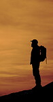 Sunset, silhouette and hiker on mountain, travel and man on adventure, mockup space and outdoor view. Backpacker, sightseeing and person on hike in nature, trip and forest exploration or vacation