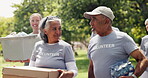 Volunteer, walk or people in park with donations, social chat or collaboration in resource relief. Stroll, conversation or team outdoor with package, discussion or distribution in food drive campaign