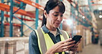 Logistics, happy and woman with smartphone, warehouse and checking stock delivery on web and typing. Factory, flare and person with mobile for distribution updates, online and research with tech