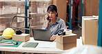 Laptop, logistics and phone call with woman at desk in warehouse for distribution or shipping update. Computer, conversation and supply chain with mature person in storage depot for delivery schedule