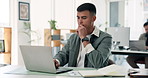 Laptop, thinking and typing with designer man at desk in office for development or solution. Computer, design and idea with artistic employee in creative workplace for planning or problem solving