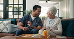 Breakfast, caregiver and senior woman on couch for elderly care, funny conversation and retirement aid. Morning chat, male nurse and old person laughing in home, support and health food for nutrition