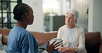 Assisted living, healthcare or tablet with nurse and old woman in apartment for feedback or review. App, consulting or medical results with caregiver and senior patient in home for discussion