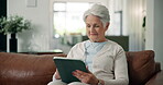 Relax, tablet and reading with old woman on sofa for social media, ebook subscription and app. Online library, retirement and calm with senior person and tech in living room of home for weekend break