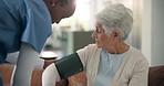 Nurse, old woman and blood pressure monitor in home on sofa for assessment, check or hypertension in retirement. Senior person, medical professional or exam on couch with healthcare test at house