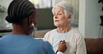 Elderly, woman or nurse with stethoscope for heart beat monitoring or healthcare exam in home. Female person, caregiver and listening with chest, breathing or senior patient for hypertension in house