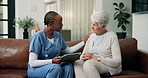 Conversation, healthcare or tablet with nurse and old woman on sofa in living room of home. App, consulting or medical results with caregiver and senior patient in apartment for feedback or review