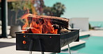 Empty, pool and bbq with fire in backyard for party, holiday and lunch on weekend outdoor. Cookout, barbecue and grill with flame, wood and heat for social gathering, celebration and vacation
