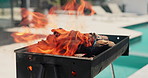 Empty, pool and bbq with flame in backyard for party, holiday and lunch on weekend outdoor. Cookout, barbecue and grill with fire, wood and heat for social gathering, celebration and vacation