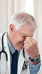 Headache, doctor and man in clinic, pain and stress with brain fog, overwhelmed and tension. Mature person, medical service and employee in office, migraine and eye strain with burnout and fatigue