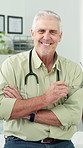 Face, happy man and mature doctor with arms folded in clinic, wellness and healthcare career. Portrait, person and medical professional with smile, confident physician and general practitioner in Uk