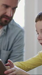 Father, son and play in home with tablet, bonding together and discussion for cognitive development. Parent, child and conversation in house with tech, digital app and educational game for learning.