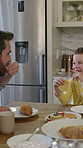 Happy, dad and son in home with breakfast, bonding together or eating in morning routine. Love, healthy relationship or people with family meal, childhood wellness or connection in start of day.