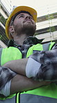 Outdoor, arms crossed or man with inspection on construction site, check or infrastructure progress. Building development, below or architect smile for property expansion, pride or project evaluation