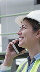 Architect, happy woman and talking on construction site with phone call, building project and planning. Smile, person and engineer outdoor with tech for contact, architecture update and conversation.