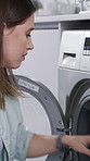 Woman, washing machine or laundry with clothing in home for hygiene, bacteria or dirt removal. Female person, chores or cleaning fabric with basket for tidy place, housekeeping duty or tasks in house