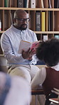 Man, teacher and reading book to children in class for education, storytelling and learning. Mature educator, talk and story with students for history, literature lesson and preparation of assessment