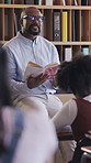 Man, teacher and reading book to students in class for education, storytelling and learning. Mature educator, talk and story with children for study, literature lesson and preparation for assessment