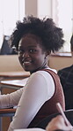 Face, girl and teen in classroom with smile, knowledge or scholarship for academic development. Education, gen z and student in high school with confidence, pride and growth in learning opportunity.