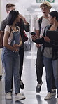 Mobile, friends walk and students with surprise for test results, education scholarship or news. High school, boys and girls with phone in hallway, talking or happy teens with shock for grade update