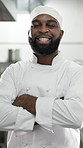 Face, black man and chef with arms crossed in restaurant kitchen for career pride as culinary expert. Portrait, male person and professional cook with smile, food preparation and ambition of catering