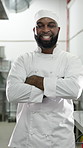 Face, black man and happy with arms crossed in restaurant kitchen for career pride as culinary expert. Portrait, male person and smile as professional cook, food preparation and ambition for catering