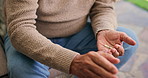 Senior man, hands and water with pills in home for symptoms, side effects or illness. Closeup, elderly or male person with medication or glass for diagnosis, chronic condition or pharmaceutical cure