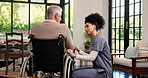 Senior man, caregiver and patient with wheelchair in home for diagnosis, assisted living or care. Healthcare, nurse and helping elderly person with a disability for health advice or recovery in house