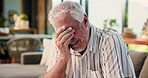 Elderly, sad man and crying in mourning with regret for past mistake, loss or grief on sofa in home. Senior, male person or emotional with regret, nostalgia or lost love for old memory or loneliness