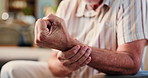 Senior man, hands and wrist pain with injury for carpal tunnel syndrome or arthritis in home. Closeup, elderly or male person with sore arm for joint inflammation, muscle tension or strain in house