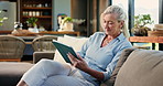Senior woman, tablet and smile on sofa, scroll and search with movie choice in living room at house. Elderly person, tech and happy on couch with application, subscription or relax in retirement home