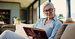 Reading, books and senior woman on sofa to enjoy literature, story and literacy in home. Retirement, living room and elderly person with novel for me time, hobby and fiction for knowledge in house